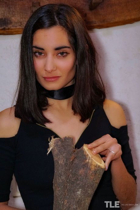 Asian teen Solange strips and shows her tiny tits and pink pussy