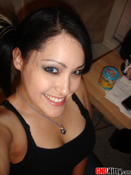 Asian teen Kitty strips and bares her amazing juggs and ass in a solo