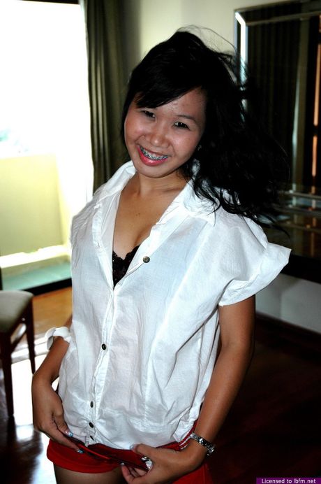 Asian amateur woman strips off and reveals her hairy pussy up close