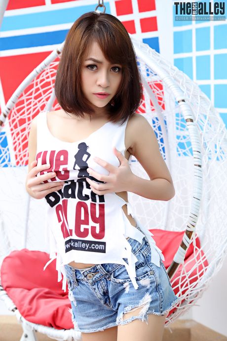 Asian teen Eileen strips and shows her hairy pussy up close