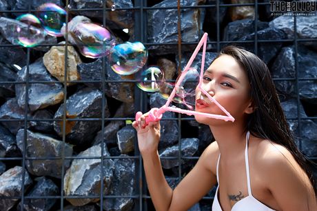 Platinum Asian Mia presents her sexy butt and hairy cunt in a solo outdoors