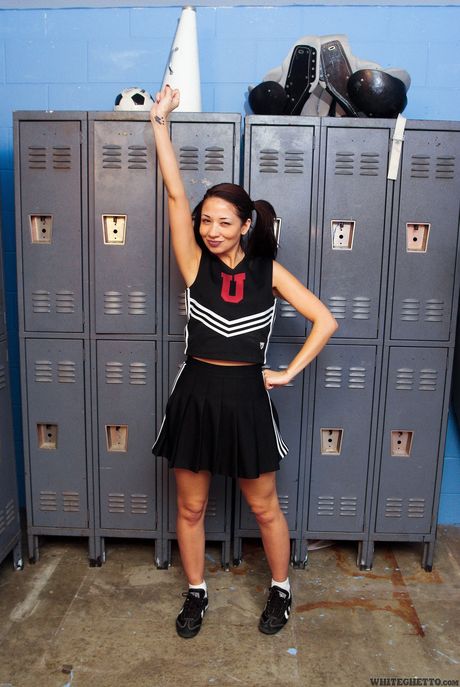 Asian cheerleader Coco Velvett strips and shows her hot ass and tits