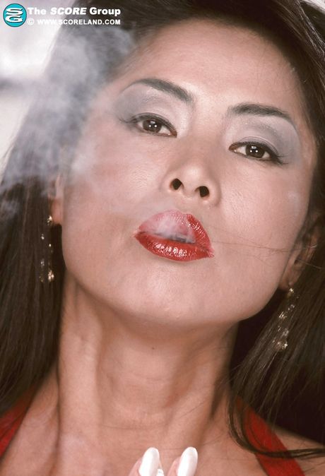 Inviting asian mature Minka enjoys smoking