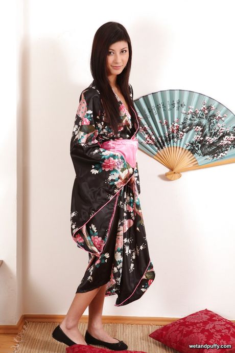 Stunning oriental babe Yvette in uniform outfit puting a toy in her pussy